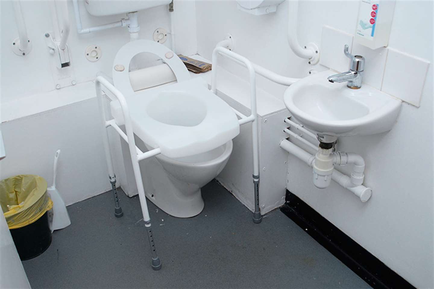 Toilet frame with raised seat