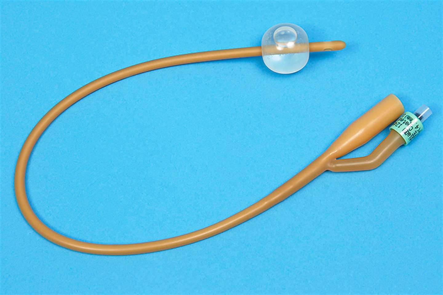 Latex Foley indwelling catheter showing inflated retention balloon