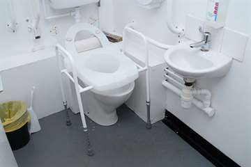 Toilet frame with raised seat
